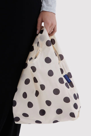 Baby BAGGU polka dot tote bag, cream with black dots, held by hand
