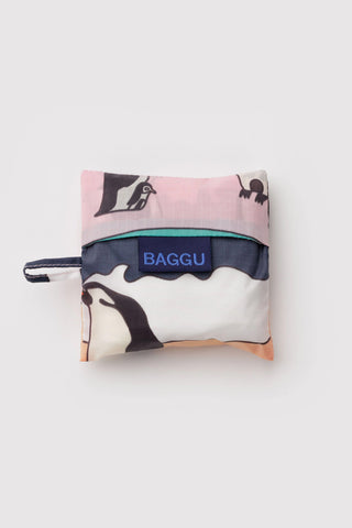 Foldable shopping bag with penguin design and 'BAGGU' branding on a light gray background