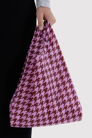 Baby BAGGU pink houndstooth tote bag held by handle