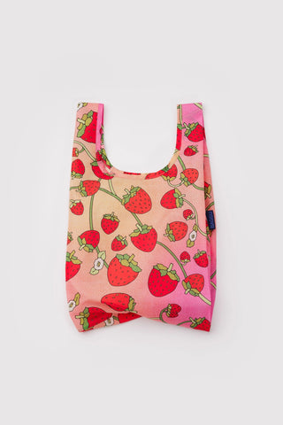 Baby BAGGU reusable tote bag in strawberry blossom print, pink with red strawberries.