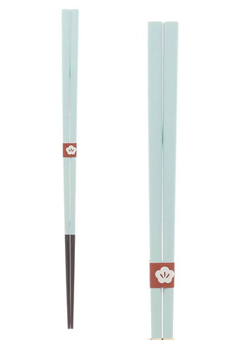 Pair of chopsticks with red packaging on a white background