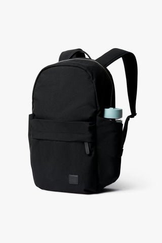 Black backpack with a water bottle on a white background