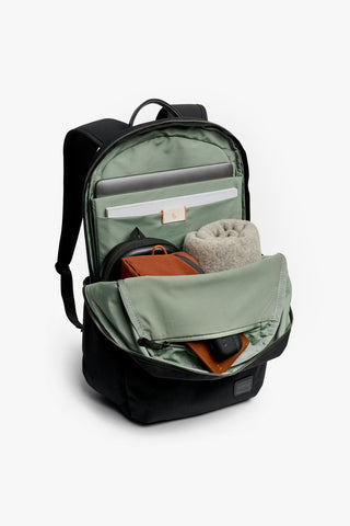 Open backpack with items on a white background