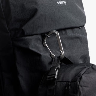 Black backpack with a carabiner and 'bellroy' branding on a light gray background