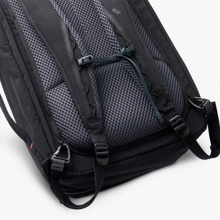Close-up of a black backpack with straps on a white background