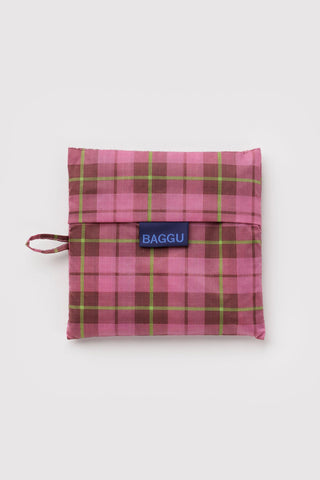 Folded BAGGU storage pouch in azalea pink tartan plaid with logo