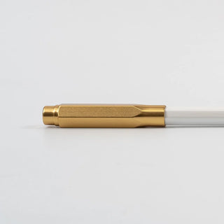 Gold pencil point guard on a white background