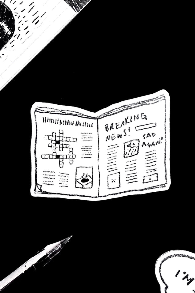 Vinyl sticker shaped like a folded newspaper, black and white with “Breaking News” text