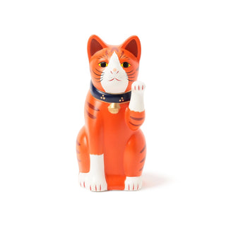 Cat-shaped figurine with its paw up with orange and white stripes on a white background