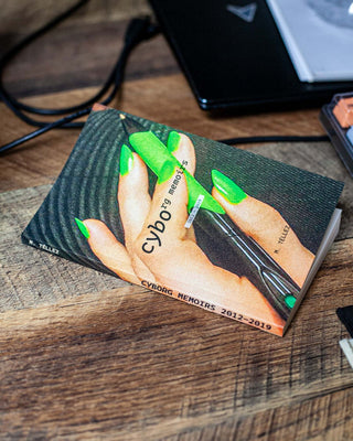 Cyborg memoirs book cover with neon green hand artwork on a dark background
