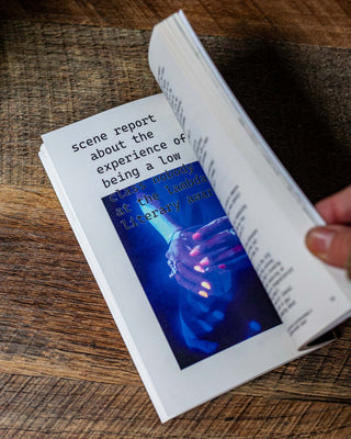 Book open to a page with “scene report” heading and blue image