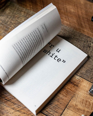 Open book with the word “white” on the page