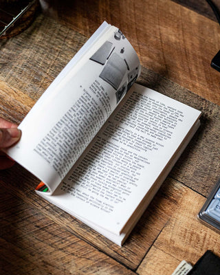 Open book spread with paragraphs of text and small photo panels
