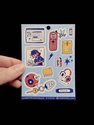 Sheet of stickers held by a hand with a black background