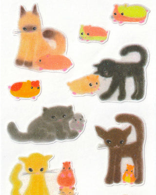 Close-up of cat and hamster sticker cutouts in orange, brown, and black poses