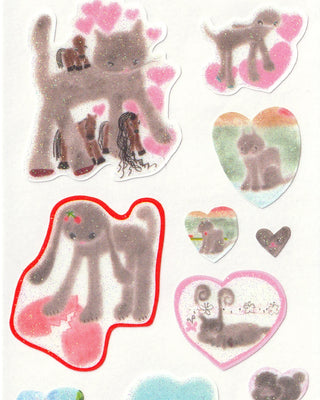 Close-up of cat and heart stickers, pastel cat silhouettes and glittery heart outlines