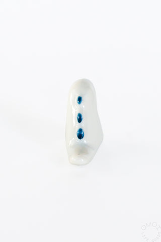 White ceramic tyrannosaurus chopstick rest, upright front angle