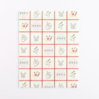 Letterset paper with grid pattern with cartoon chinchillas and vegetables