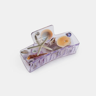 Clear seashell claw clip with starfish and shell accents inside