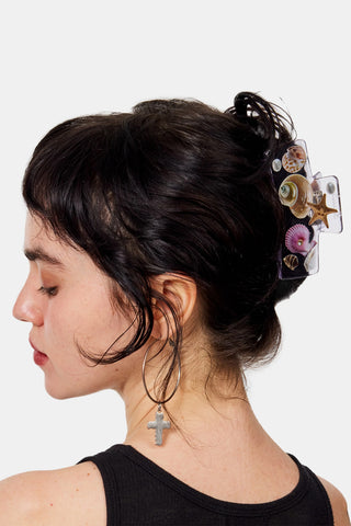 Claw clip holding hair back with seashell and starfish charms
