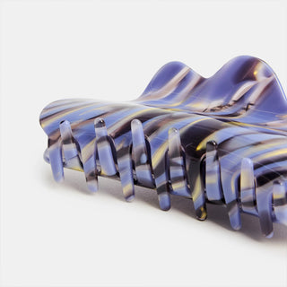 Translucent blue claw clip with wavy marble pattern and long teeth