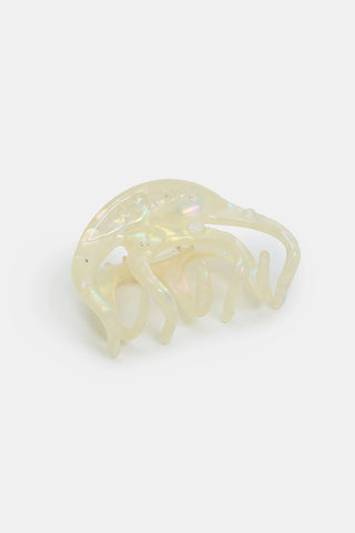 Large pearl-shimmer octopus claw hair clip in iridescent pale color
