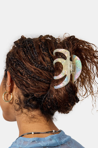 Iridescent pearl octopus claw hair clip on curly brown hair