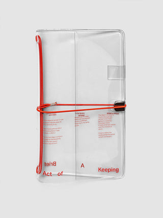 A clear plastic notebook cover with red printed text and a red elastic band closure, shown on a light gray background.