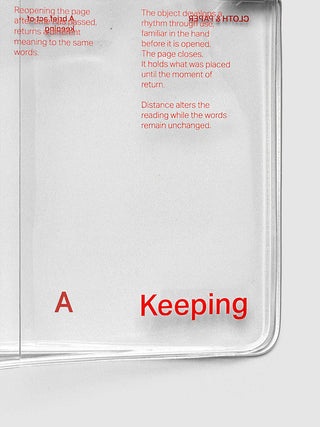 A clear notebook cover with red printed text and the word 'Keeping' in large red letters on a light gray background.