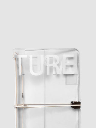 Transparent notebook cover with large text 'APERTURE' with light colored notebook bands