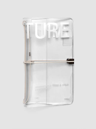 A clear acrylic notebook cover with a white elastic closure band and a small metal clasp, shown on a light gray background.