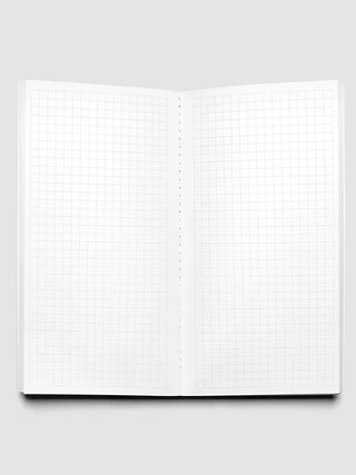Opened travel notebook showing dotted graph grid pages