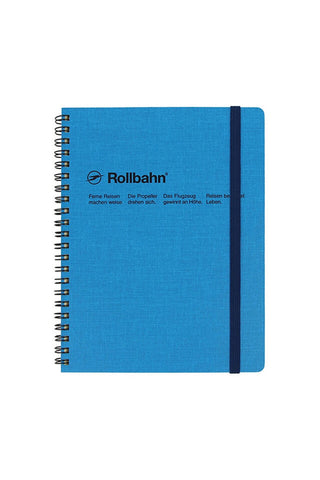 Large blue spiral notebook with dark-blue elastic strap on right edge