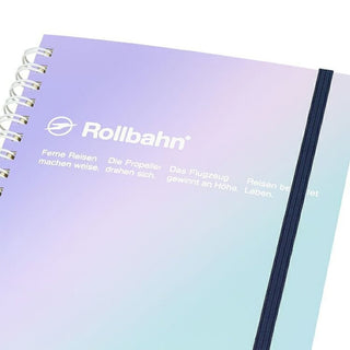Rollbahn spiral notebook with metallic gradient cover and navy spine trim, close-up