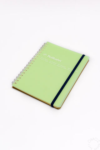Green spiral notebook with black elastic band