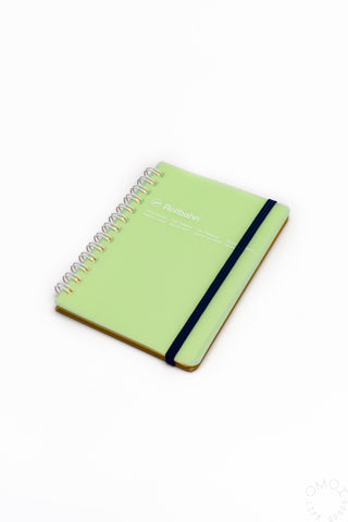 Green spiral notebook with black elastic strap