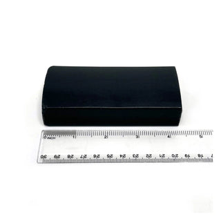 Dark rectangular soap bar with measuring ruler, centered on white