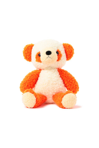 Small orange and white stuffed animal toy on a white background