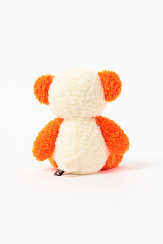 Small panda plush toy with orange ears and arms on a white background