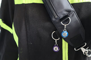 Black bag strap with numbered pool ball keychains attached