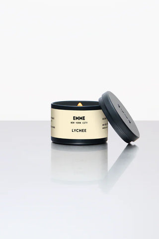 Emme Lychee candle on a white surface with a white background