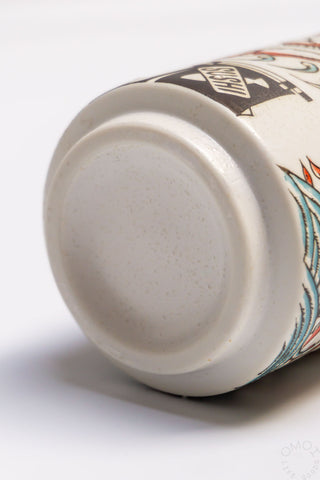 Fish teacup underside view, cream ceramic base with painted rim and fish art