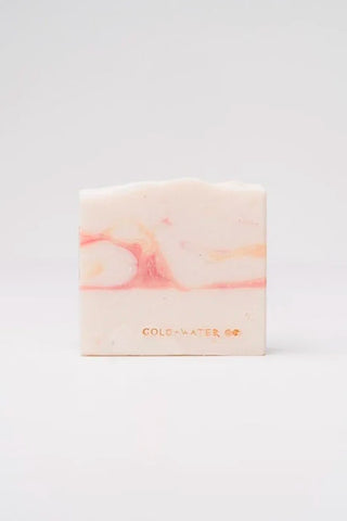 Handcrafted soap bar with peach swirl, pale cream and light pink, labeled Gold+Water Co.
