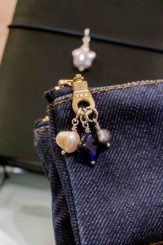 Three pack charms on a denim pencil case zipper