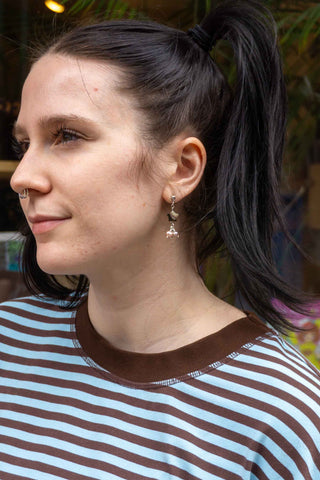Profile of person wearing star pearl earring