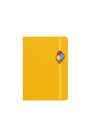 A bright yellow hardcover notebook with a yellow elastic closure band and a small colorful balloon-shaped design on the front, shown against a plain white background.