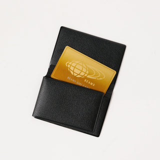 Opened black card case with the a card coming out on a white background