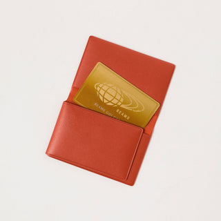 Opened red card case with the a card coming out on a white background