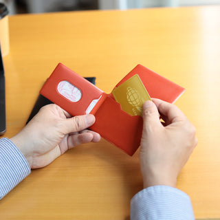 opened red card holder on a wooden table