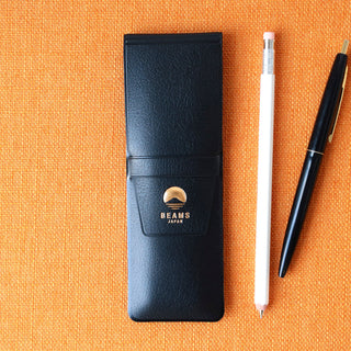 Black pen case with 'Beams Japan' logo on an orange background, accompanied by a white pencil and a black pen.
